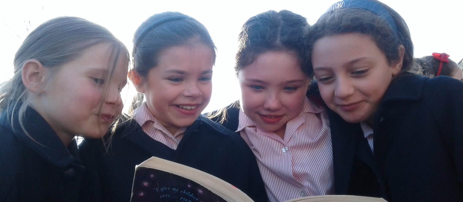 4 girls reading book