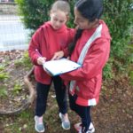 Girls working on a clipboard