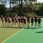 girls lined up on the astroturf