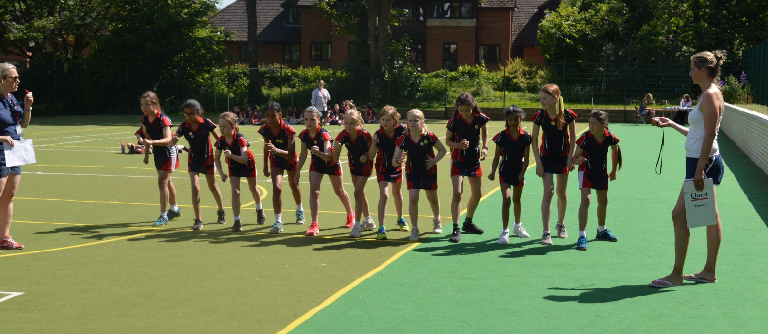 girls lined up on the astroturf