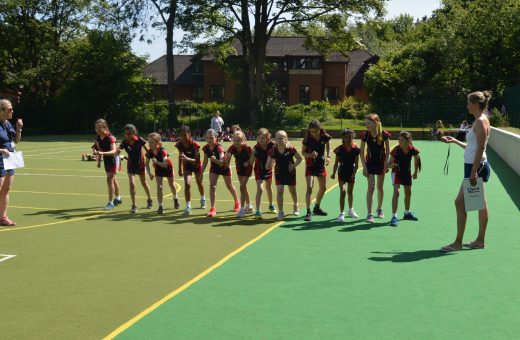 girls lined up on the astroturf