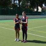 2 students holding a trophy