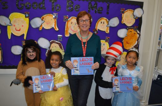 Teacher and students holding Leo's ladder book