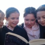 4 girls reading book