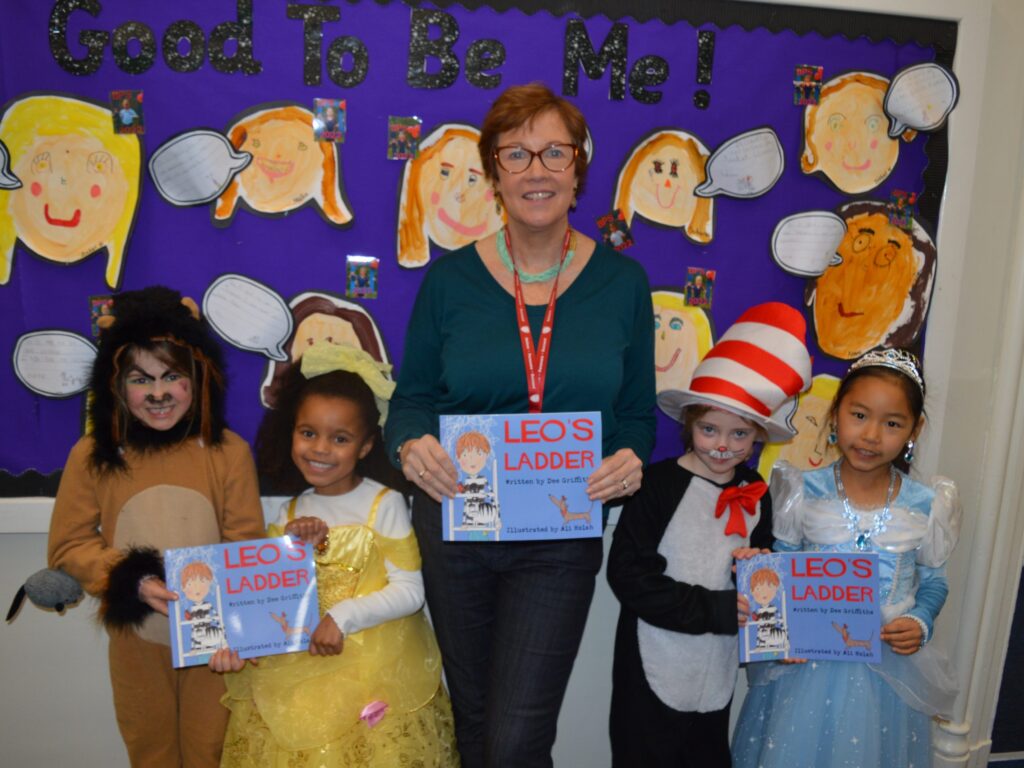 Teacher and students holding Leo's ladder book