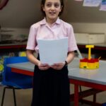 Girl holding a piece of paper