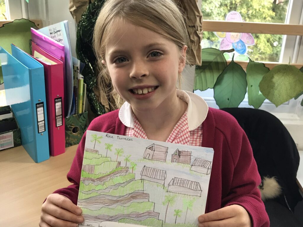 student holding her work