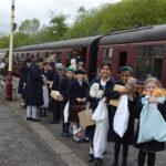 students by a train