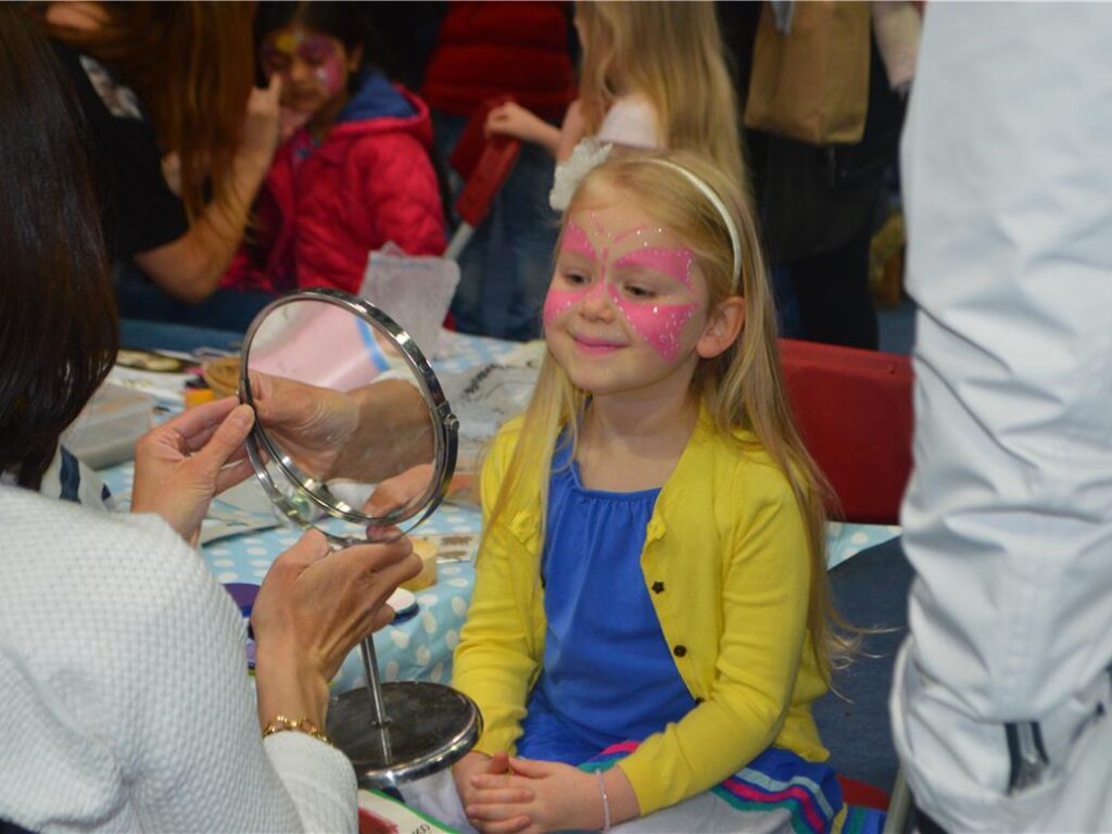 girl looking at her face paint