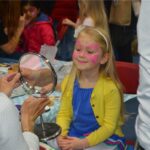 girl looking at her face paint