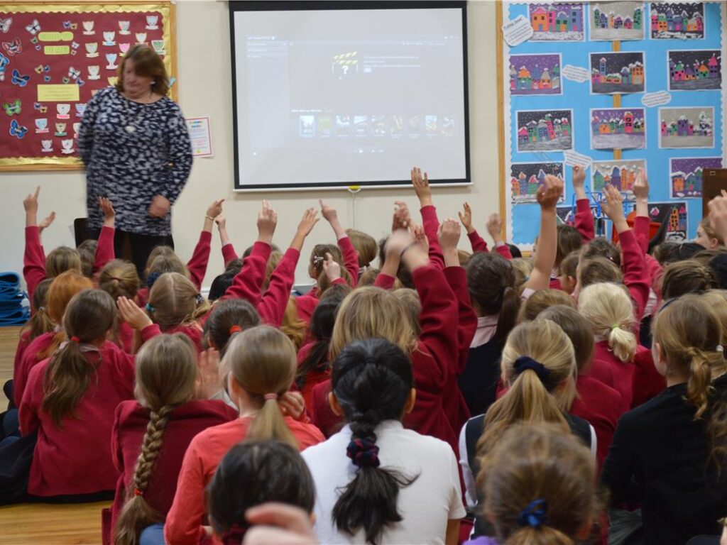students with their hands up