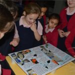 students reading a poster