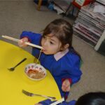 student eating noodles